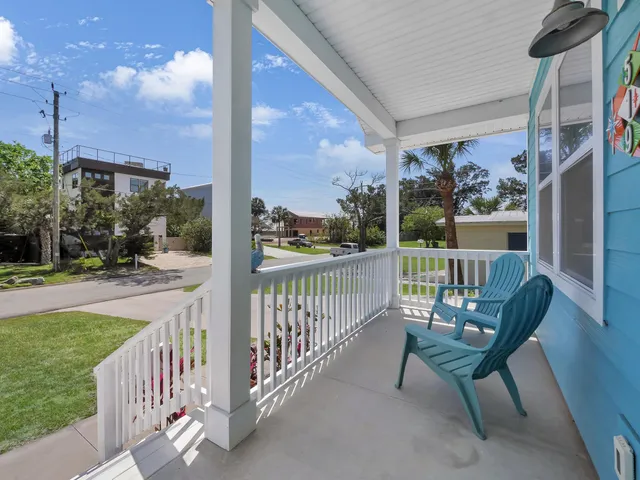 a view of a porch with furniture and a yard