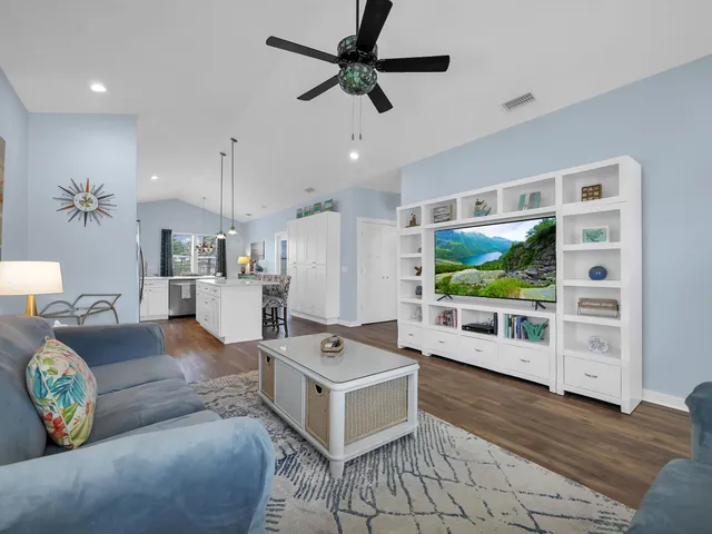 a living room with furniture flat screen tv and white walls