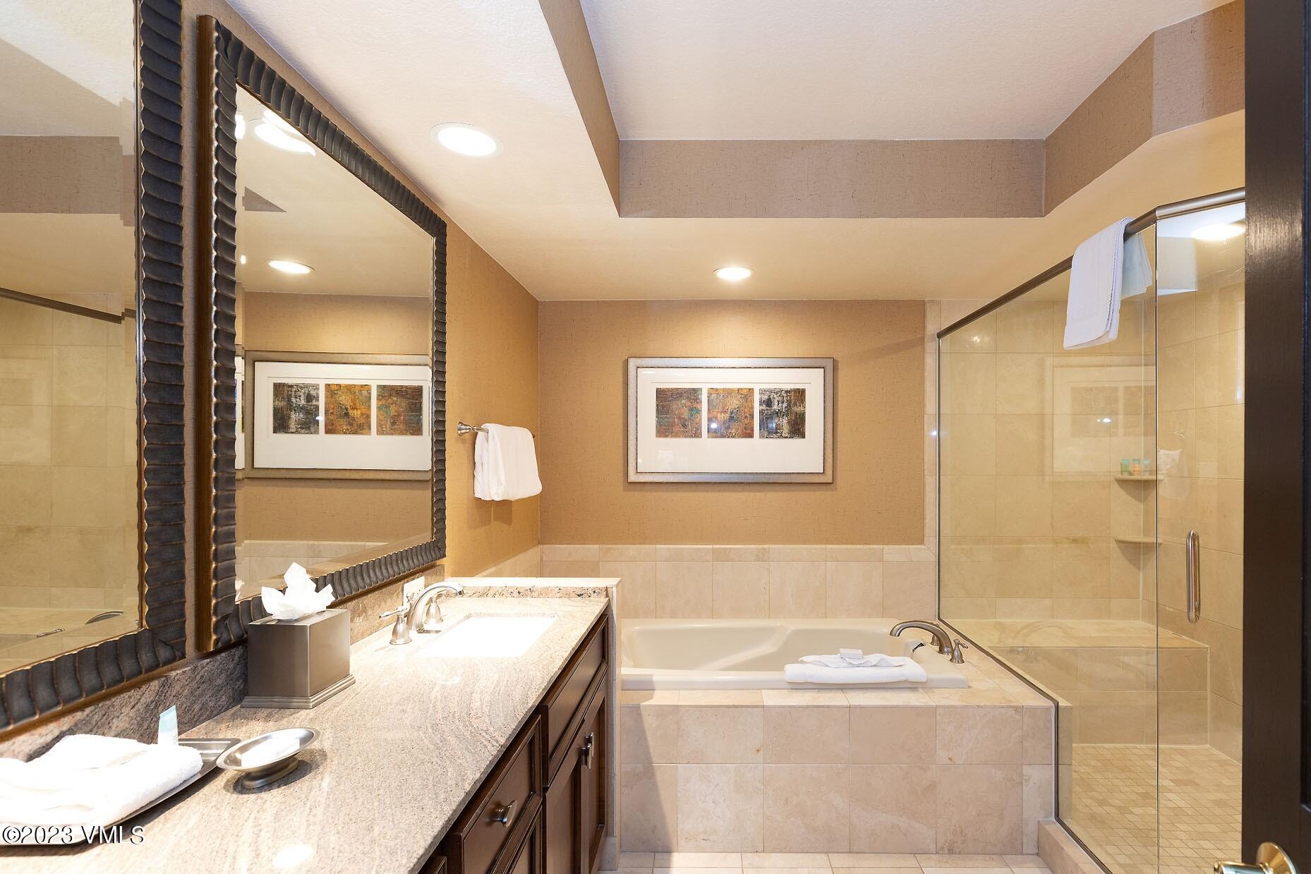 210 Offerson Road, Unit R115 WEEK 49 Beaver Creek, CO 81620 - Photo 15 of 30 a bathroom with a granite countertop sink a bathtub and a mirror