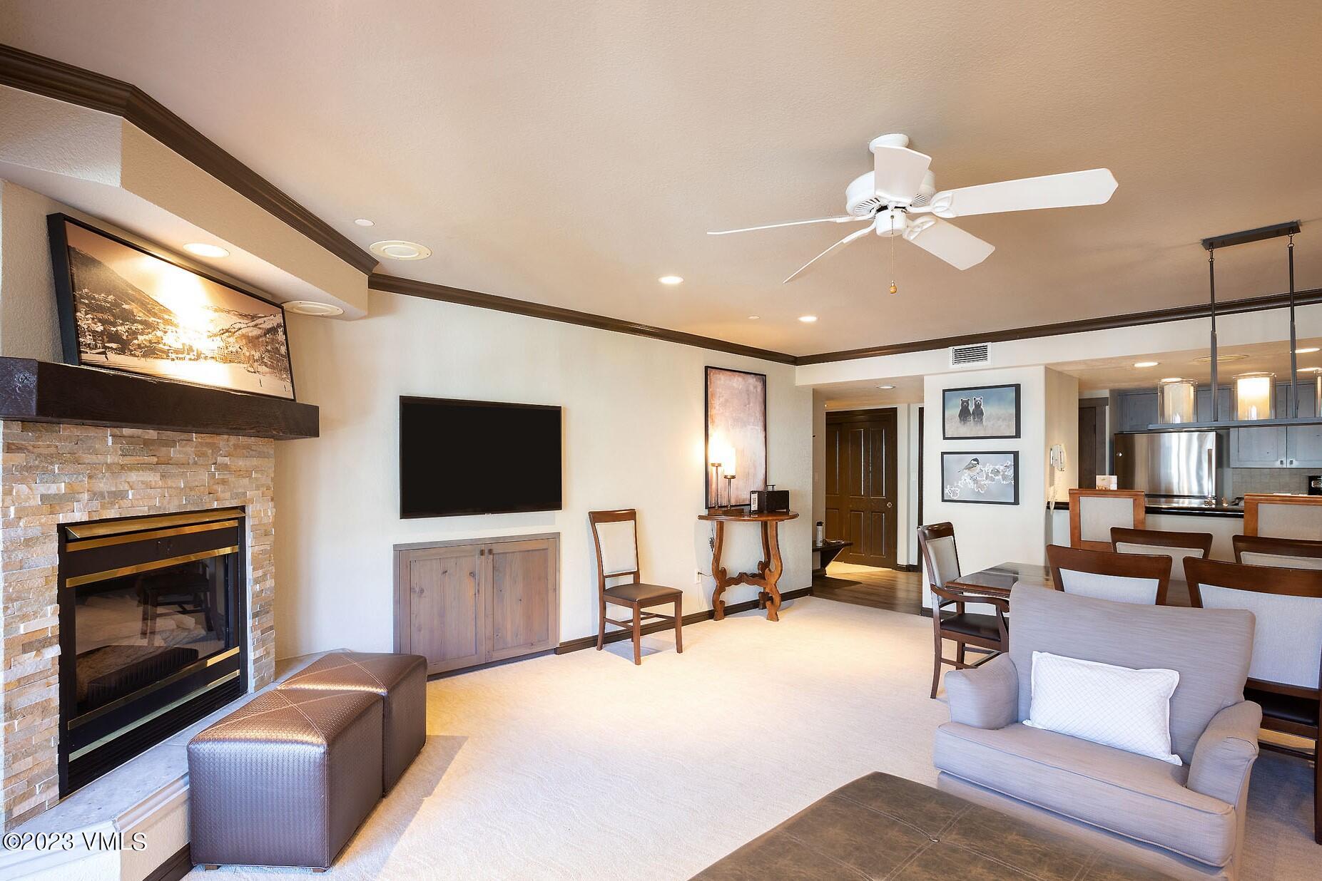 210 Offerson Road, Unit R115 WEEK 49 Beaver Creek, CO 81620 - Photo 2 of 30 a living room with furniture a fireplace and a flat screen tv