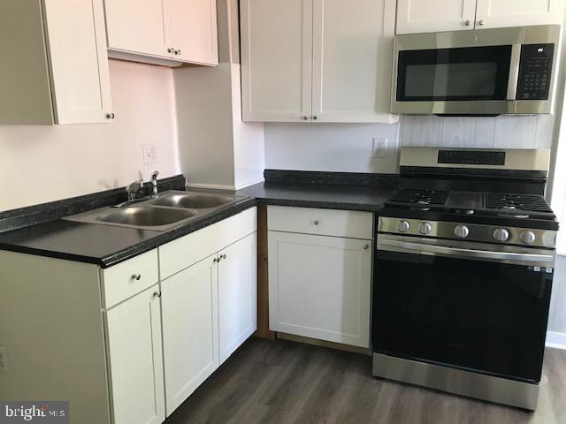146 Pleasant Street Hanover, PA 17331 - Photo 11 of 13 a kitchen with stainless steel appliances granite countertop a sink and a microwave