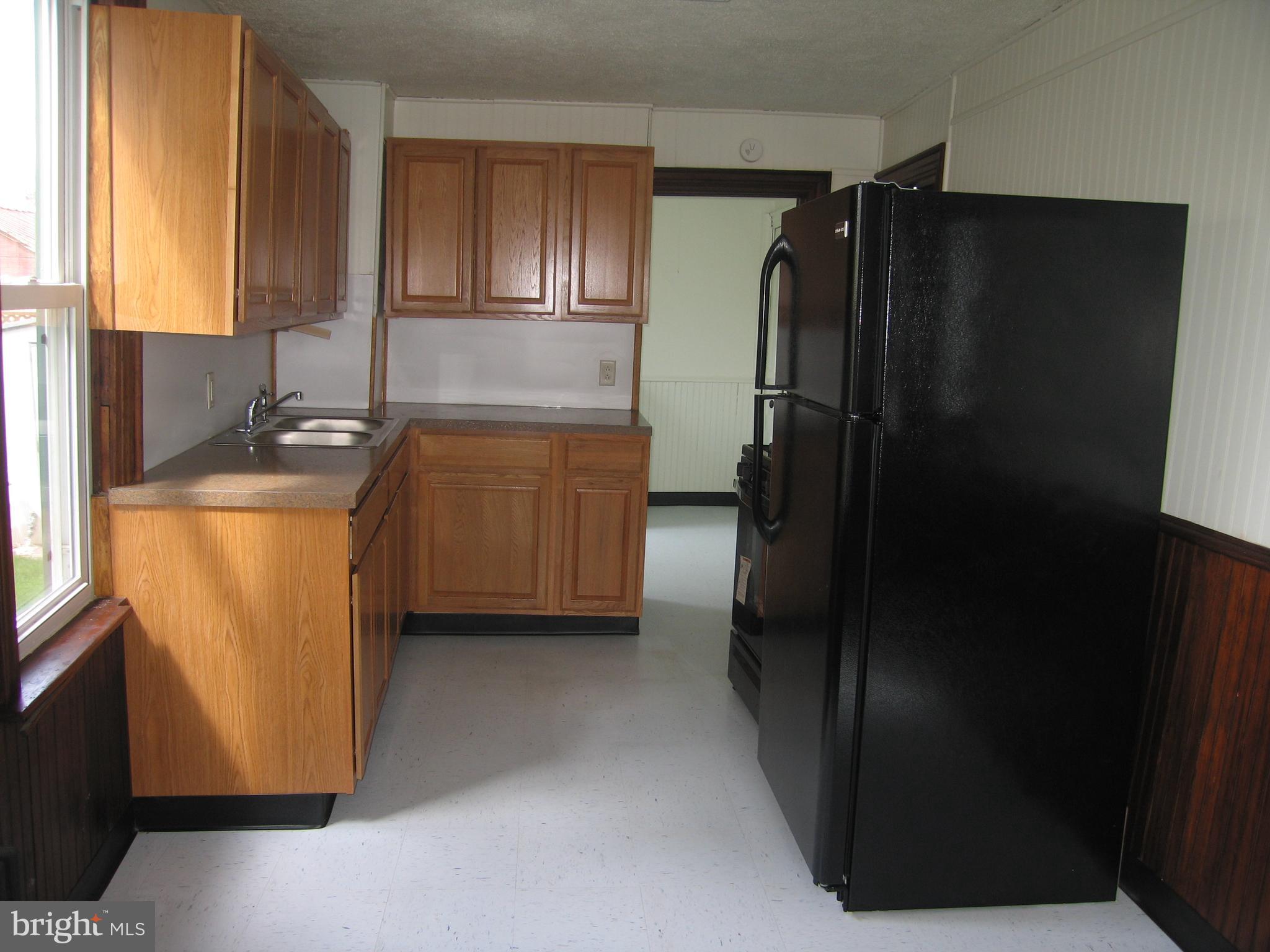 146 Pleasant Street Hanover, PA 17331 - Photo 2 of 13 a kitchen with granite countertop a refrigerator and a sink