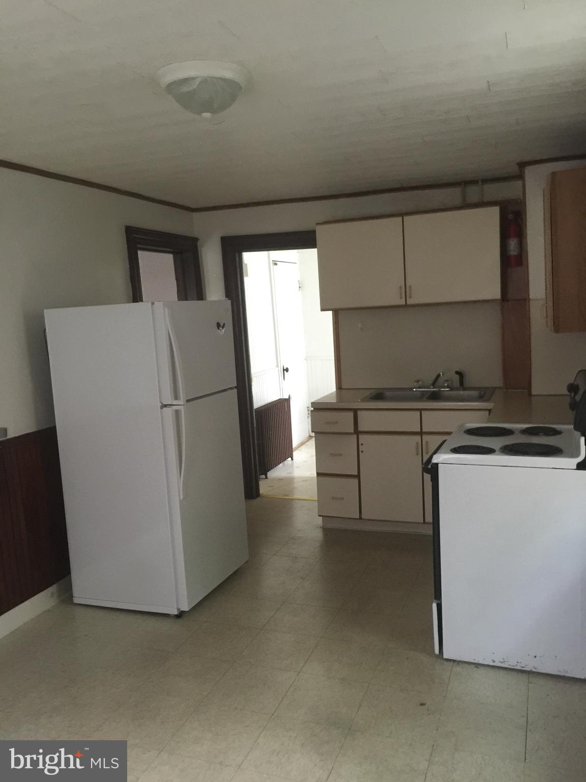 146 Pleasant Street Hanover, PA 17331 - Photo 8 of 13 a kitchen with cabinets a refrigerator and a stove