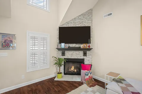 a living room with furniture a flat screen tv and a fireplace