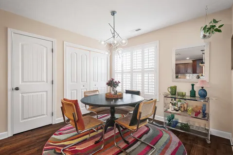 a dining room with furniture and wooden floor