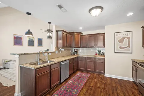 a spacious bathroom with a granite countertop sink and a mirror