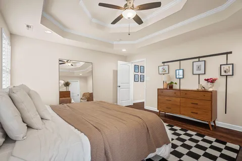 a bedroom with a bed and a chandelier