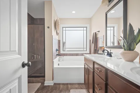 a bathroom with a granite countertop sink tub and a mirror