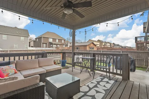 a balcony with furniture and a potted plant