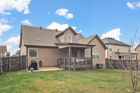 a view of a house with a swimming pool and a yard