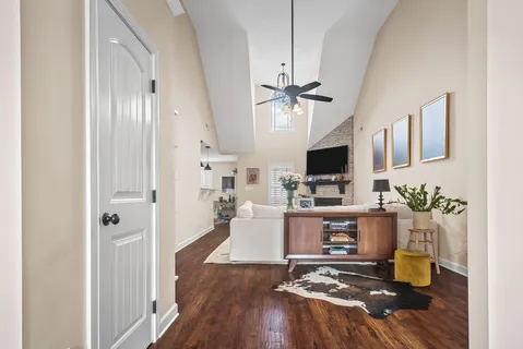 a living room with fireplace furniture and a flat screen tv