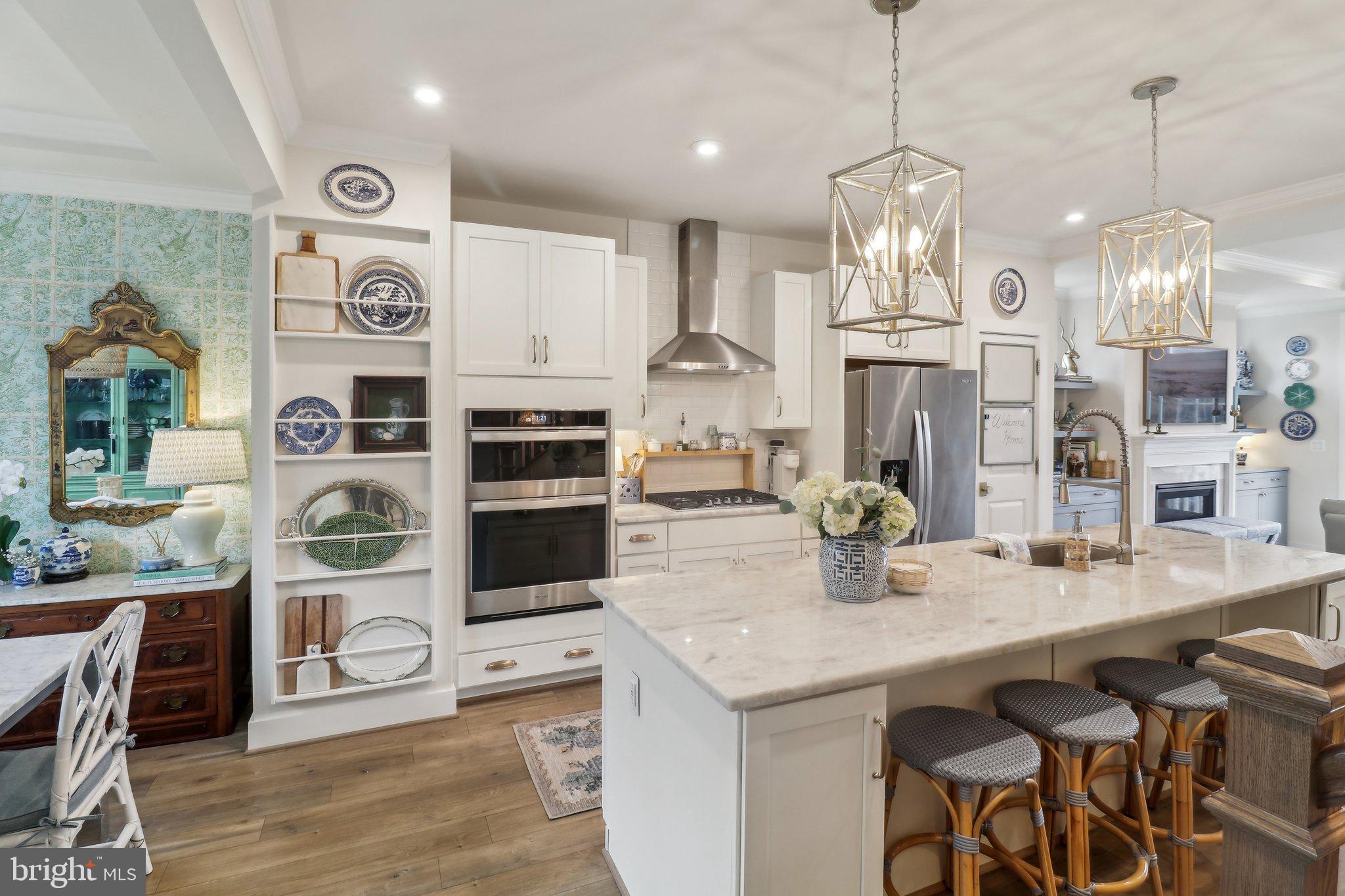 2256 South Glebe Road Arlington, VA 22206 - Photo 14 of 53 a kitchen with stainless steel appliances kitchen island granite countertop a table and chairs in it