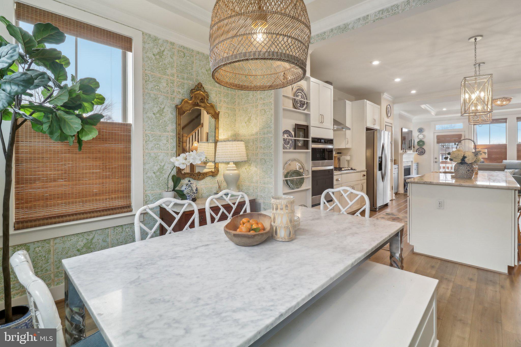 2256 South Glebe Road Arlington, VA 22206 - Photo 17 of 53 a kitchen with stainless steel appliances granite countertop a table chairs and a wooden floor