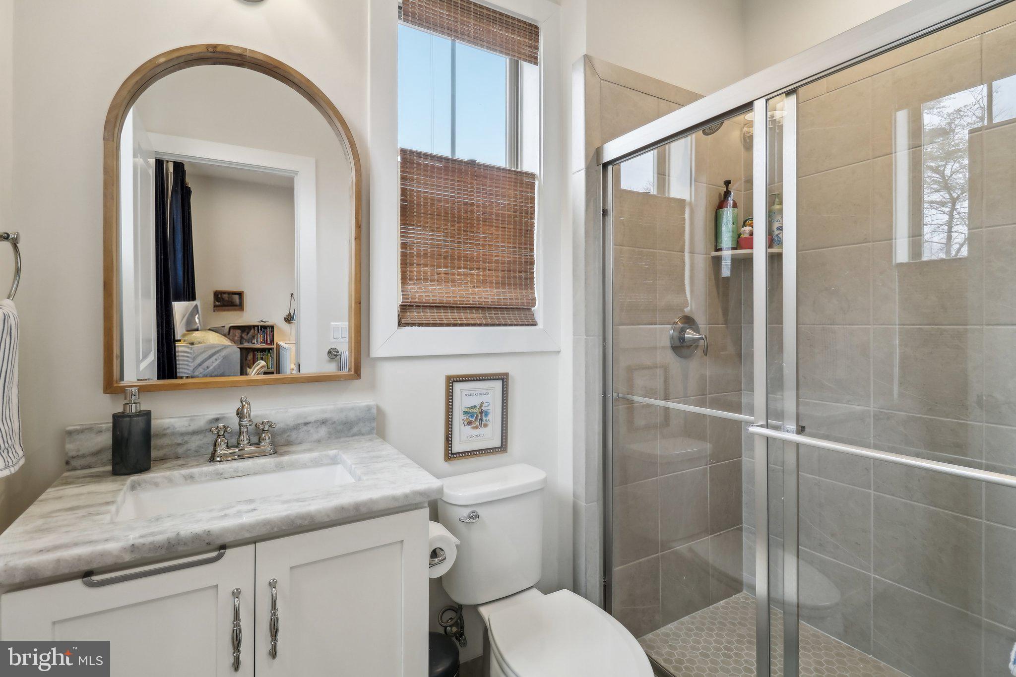 2256 South Glebe Road Arlington, VA 22206 - Photo 38 of 53 a bathroom with a granite countertop sink toilet and shower