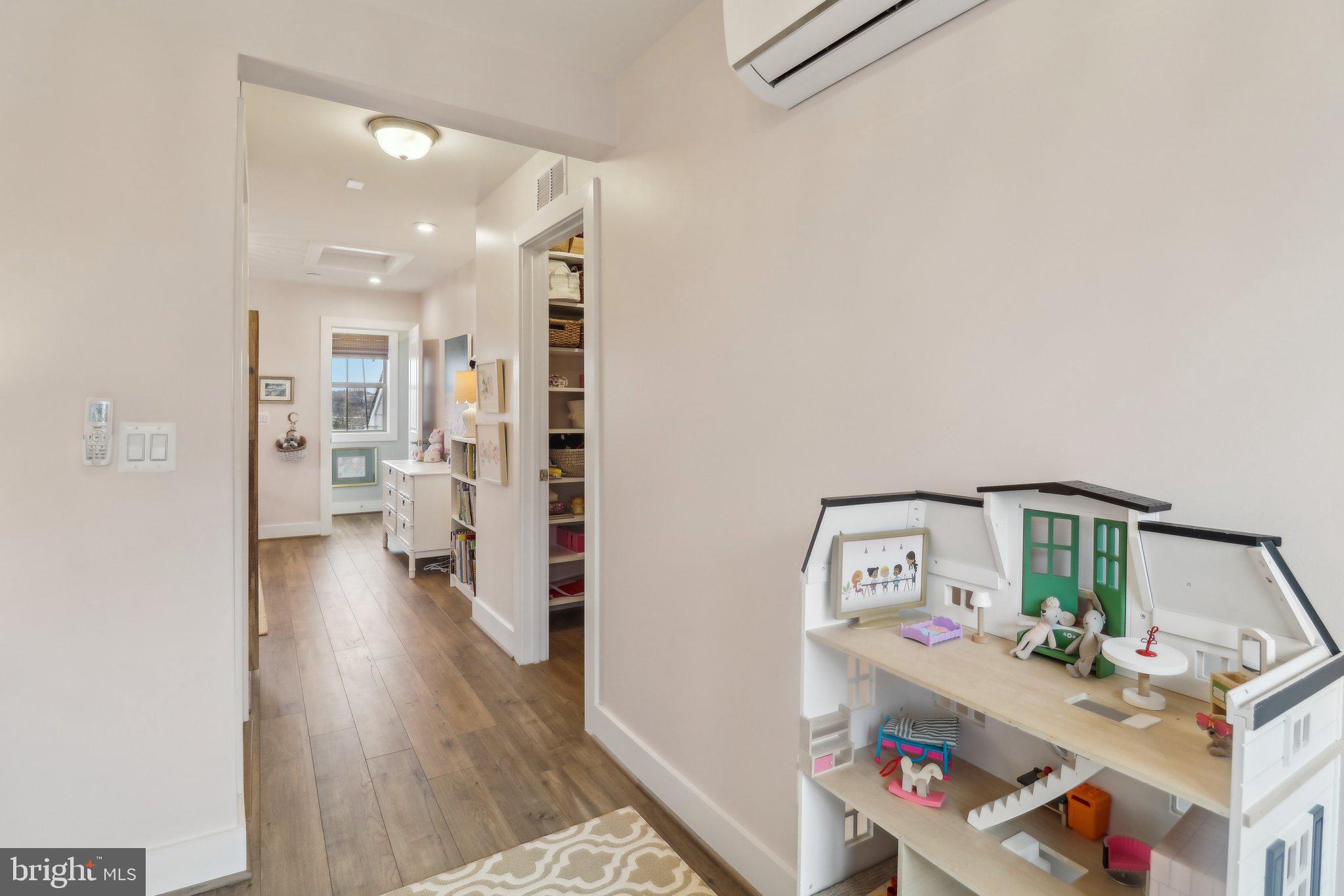 2256 South Glebe Road Arlington, VA 22206 - Photo 45 of 53 a view of a hallway to a livingroom with wooden floor