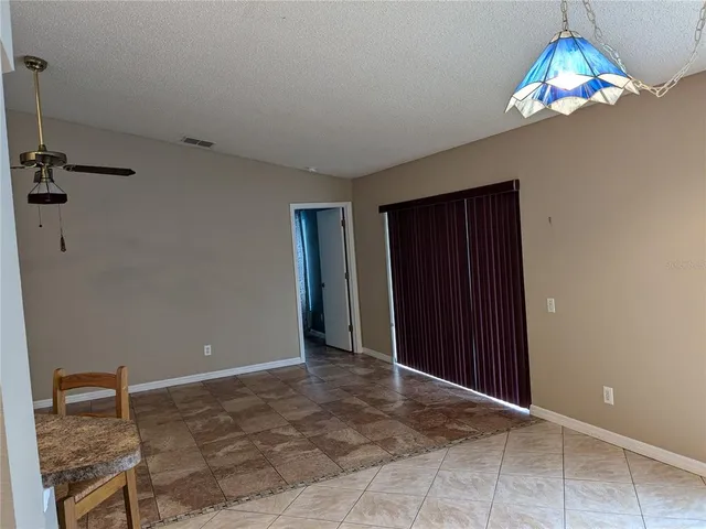 a view of an empty room with a chandelier