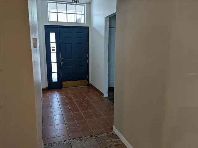 an empty room with washing machine and closet