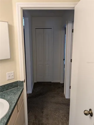 a kitchen with granite countertop a refrigerator and a stove top oven
