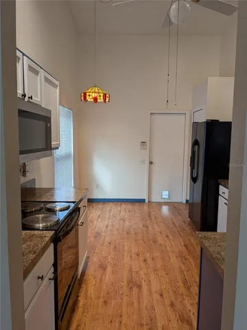 a kitchen with stainless steel appliances granite countertop a refrigerator stove and sink