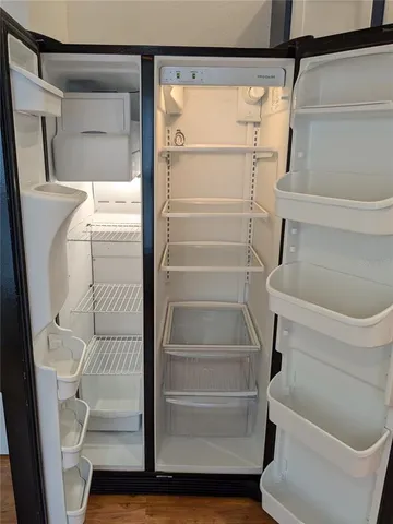 a kitchen with stainless steel appliances granite countertop a refrigerator a stove and a sink