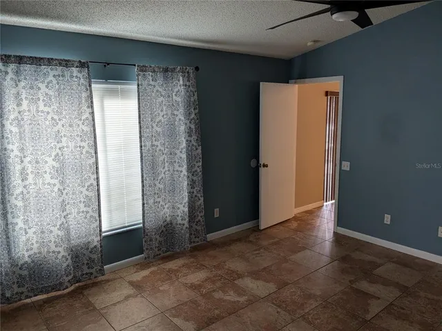 a room with a mirror and a ceiling fan