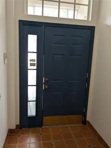 a kitchen with refrigerator and cabinets