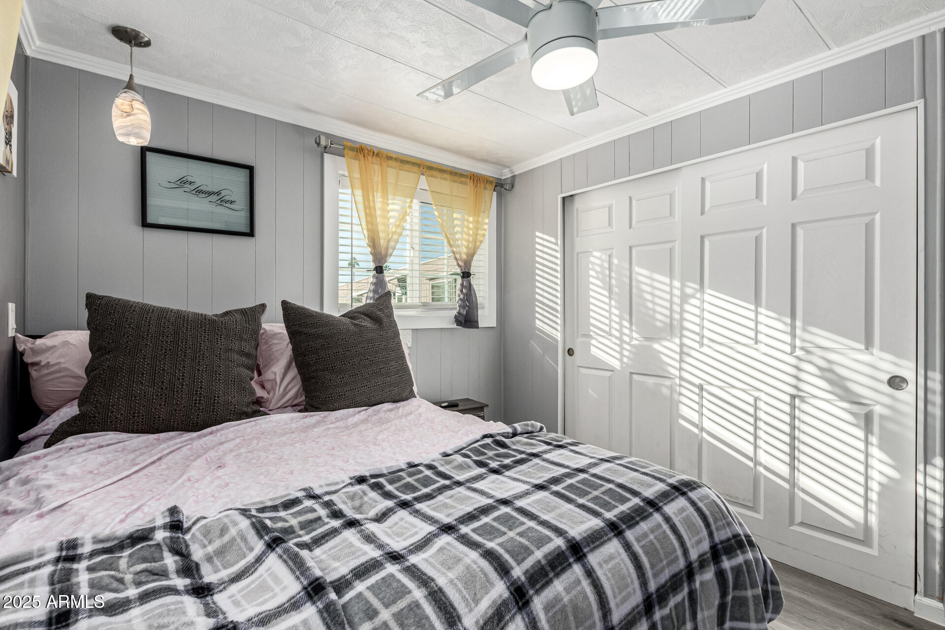 15606 South Gilbert Road, Unit 109 Chandler, AZ 85225 - Photo 11 of 49 a bedroom with a large bed and a chandelier