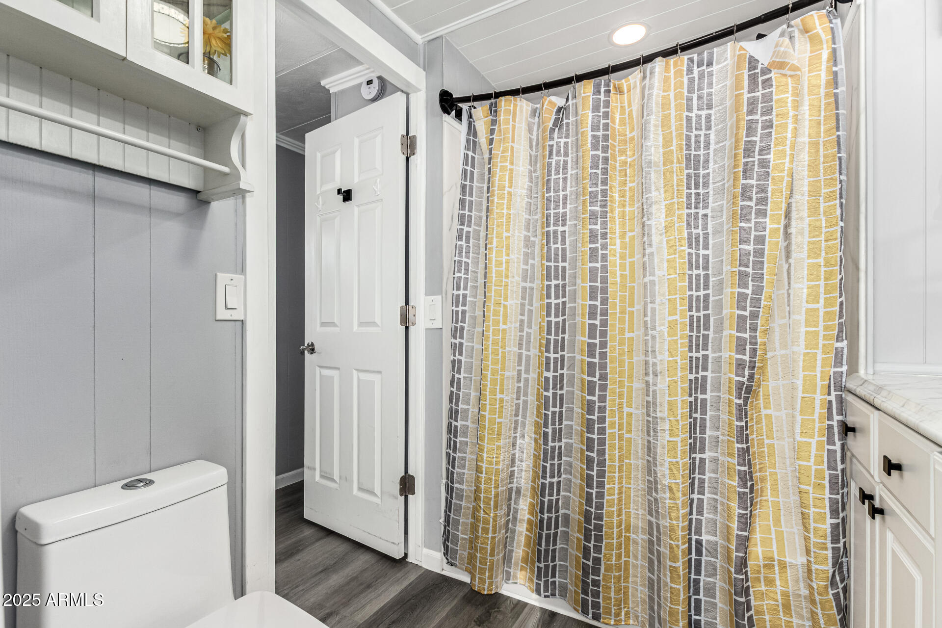 15606 South Gilbert Road, Unit 109 Chandler, AZ 85225 - Photo 14 of 49 a bathroom with a shower curtain and a toilet