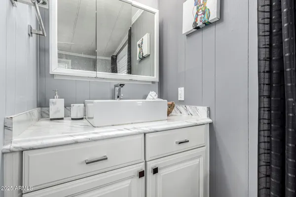 a bathroom with a sink and a mirror