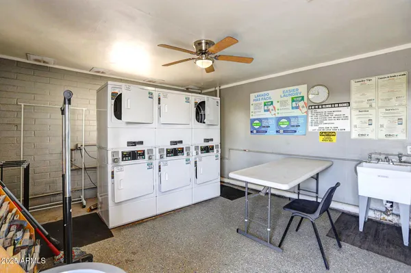 a large white kitchen with a refrigerator a stove top oven a counter space and cabinets