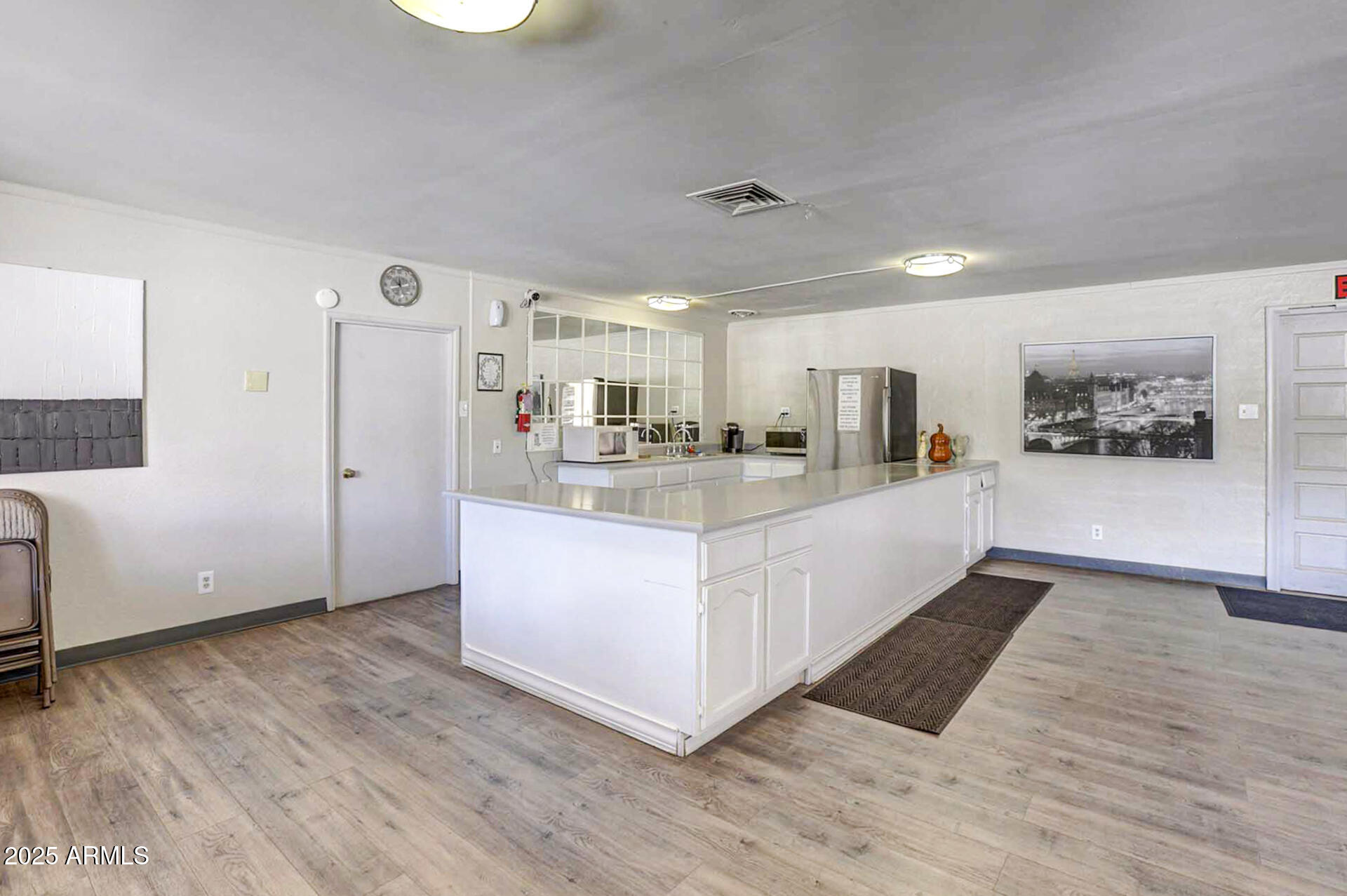 15606 South Gilbert Road, Unit 109 Chandler, AZ 85225 - Photo 36 of 49 a large white kitchen with a refrigerator a stove top oven a counter space and cabinets