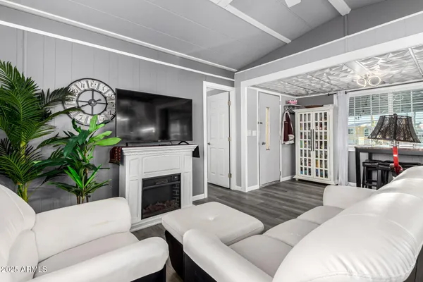 a living room with furniture a flat screen tv and a fireplace