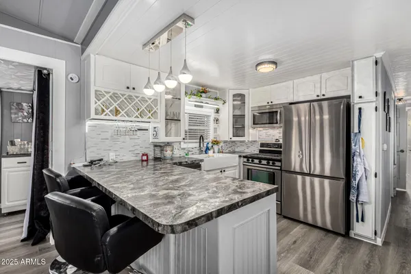a kitchen with granite countertop a refrigerator a stove and a sink