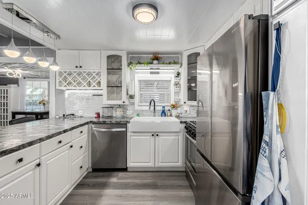a kitchen with cabinets and stainless steel appliances