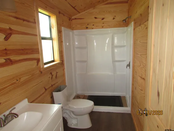 a bathroom with a shower a toilet and a sink