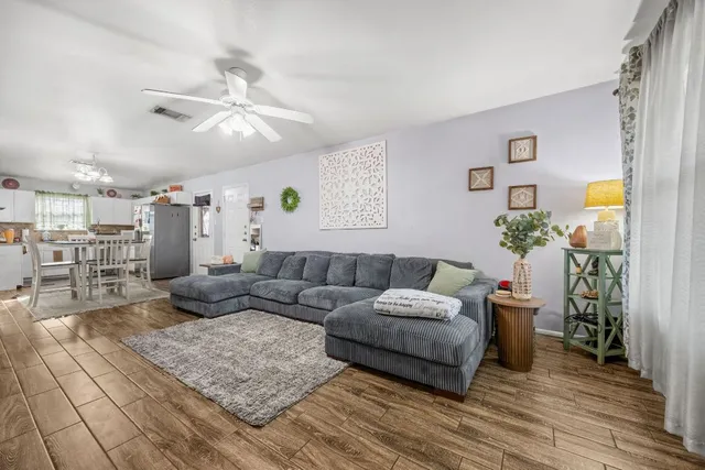 a living room with furniture and a chandelier