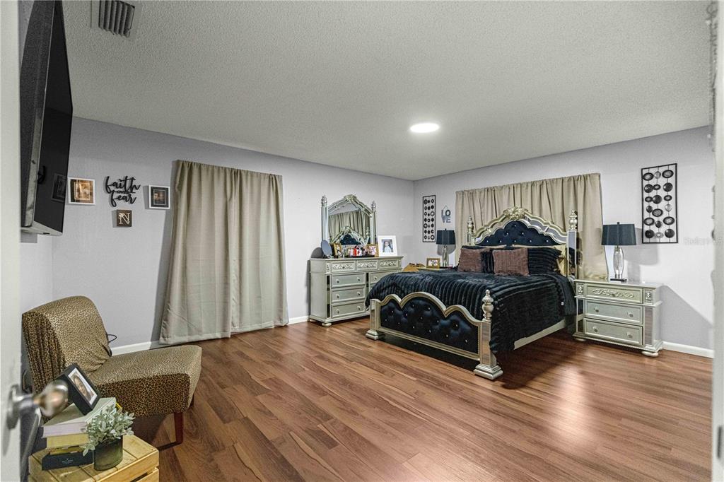 508 Emerald Road Ocala, FL 34472 - Photo 11 of 32 a bedroom with a bed and wooden floor