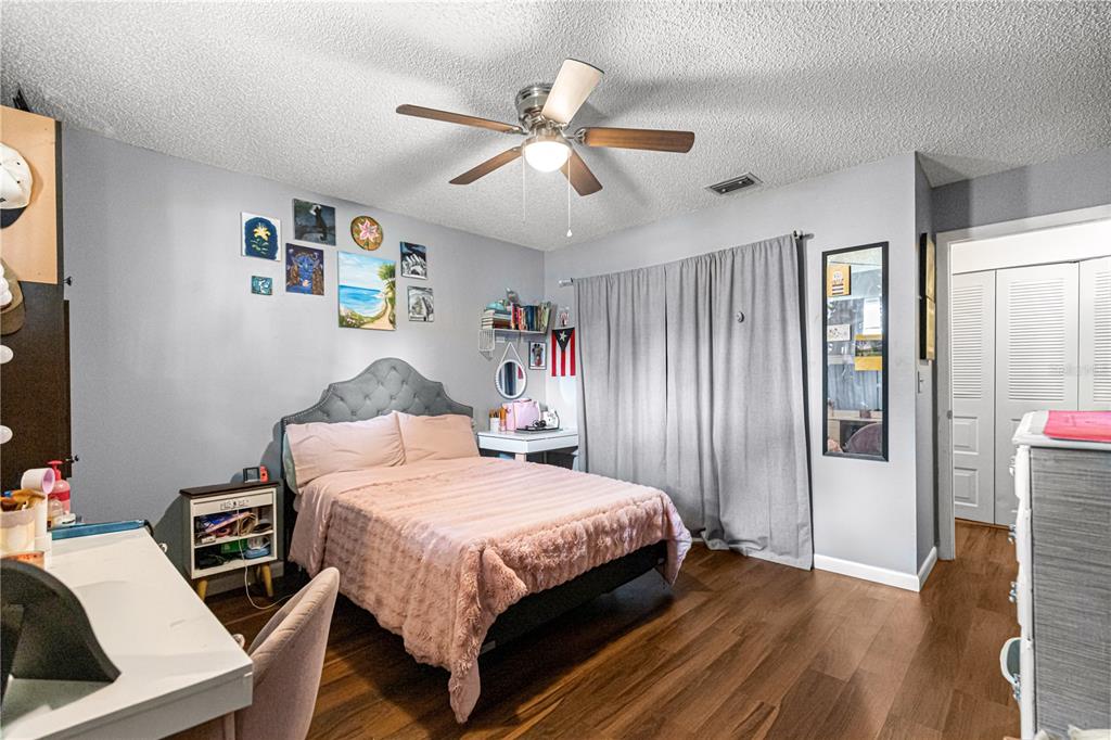 508 Emerald Road Ocala, FL 34472 - Photo 26 of 32 a bedroom with a bed and a chandelier