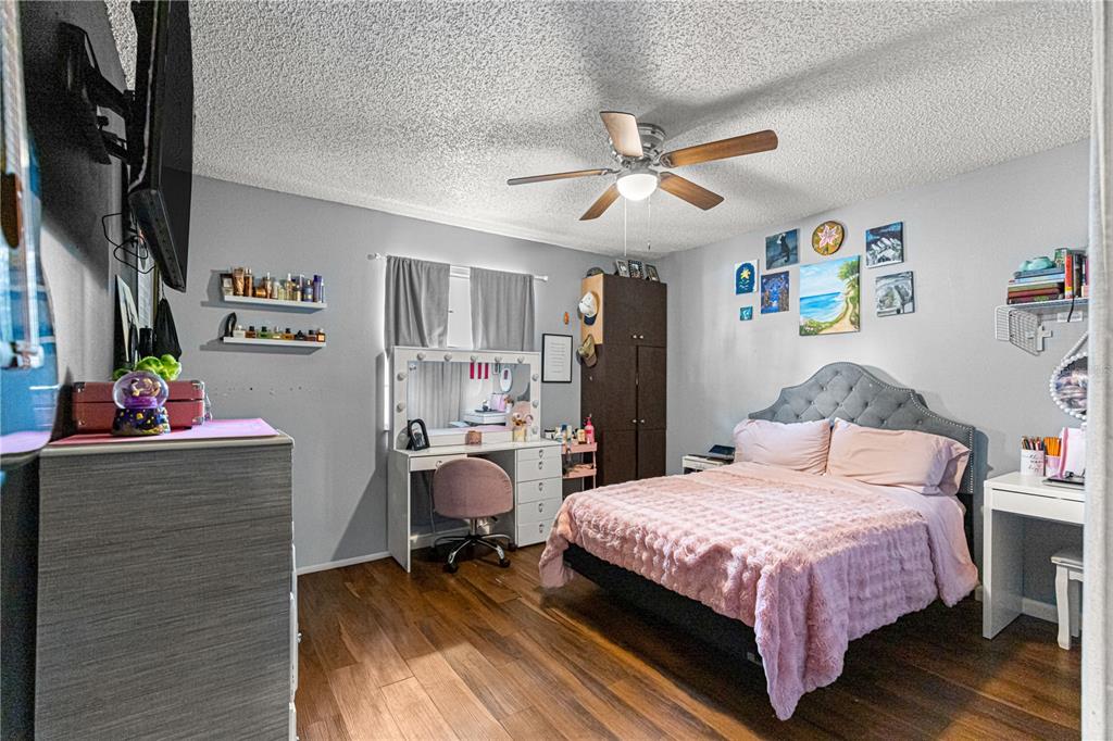 508 Emerald Road Ocala, FL 34472 - Photo 27 of 32 a bedroom with a bed and a chandelier