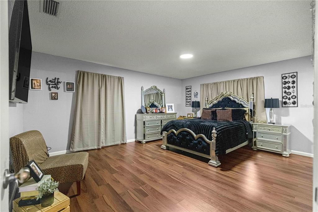 508 Emerald Road Ocala, FL 34472 - Photo 3 of 32 a bedroom with a bed and wooden floor