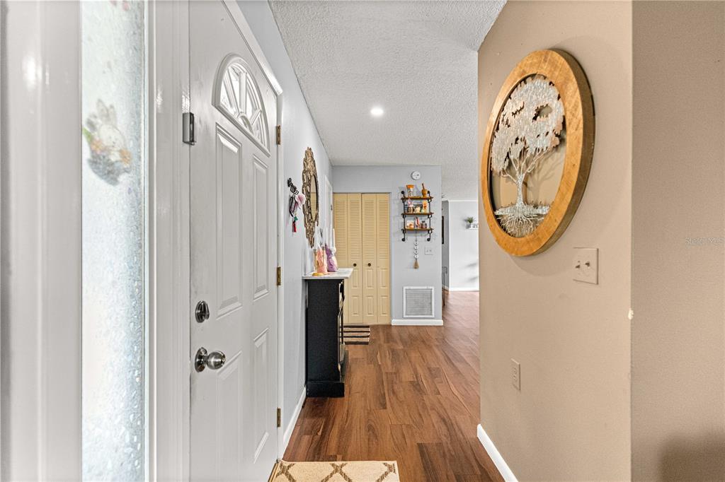 508 Emerald Road Ocala, FL 34472 - Photo 8 of 32 a view of a hallway with wooden floor