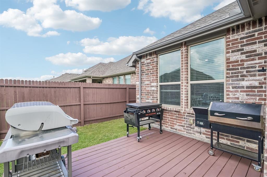 1805 Huntsman Way Forney, TX 75126 - Photo 31 of 34 Expansive outdoor deck crafted from composite materials, featuring a brick exterior and a privacy fence