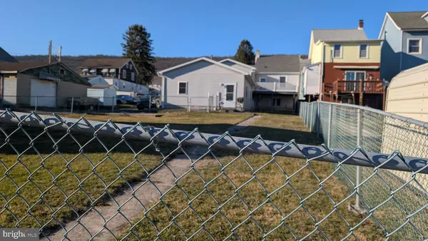 a front view of a house with swimming pool and porch