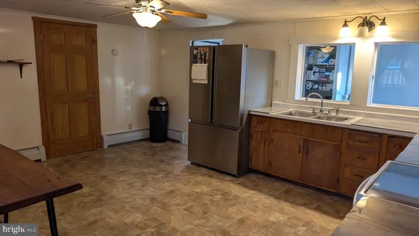 a kitchen with a refrigerator and a sink