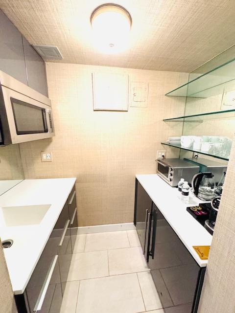 111 East 56th Street, Unit 712 Manhattan, NY 10022 - Photo 3 of 16 a kitchen with a sink and cabinets