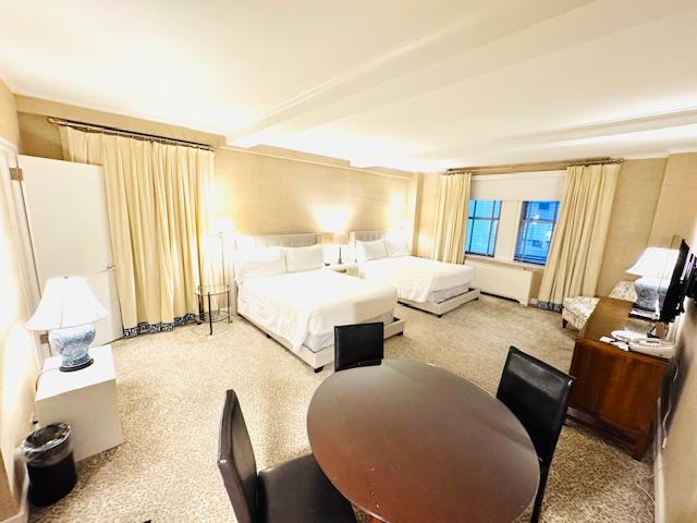 111 East 56th Street, Unit 712 Manhattan, NY 10022 - Photo 5 of 16 a living room with furniture and a flat screen tv