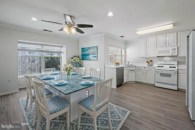 a view of kitchen with cabinets table and chairs