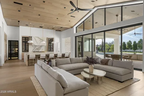 a living room with furniture a large window