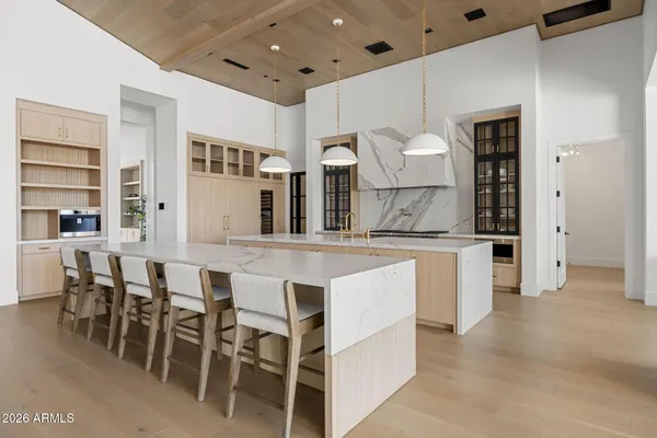 a kitchen with a table chairs and a window