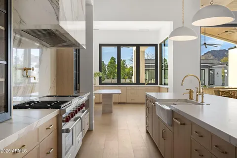 a kitchen with a table chairs and a window